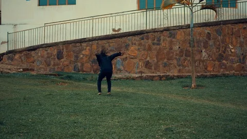 Acrobatic teenager doing backflip while practicing parkour  Stock Footage 117685852