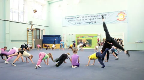 Acrobatic training with istructor in urban children and youth sports center Stock Footage 33662653