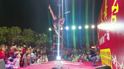Acrobatics performer performing in front of people at horizontal composition Stock Footage 235755571