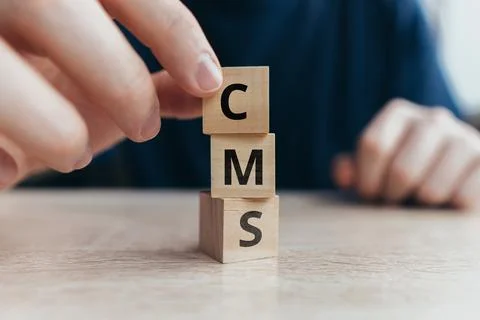 Acronym CMS or Content Management System. Text on wooden cubes Stock Photos