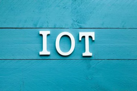 The acronym IOT Internet of things on blue background Stock Photos