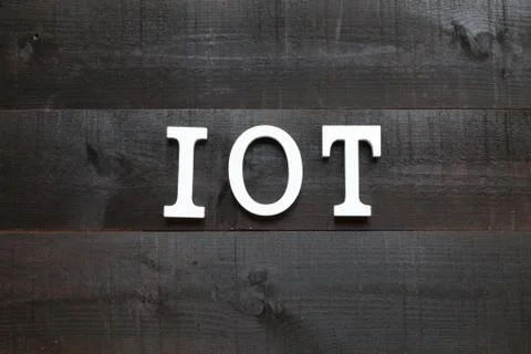 The acronym IOT Internet of things on dark background Stock Photos