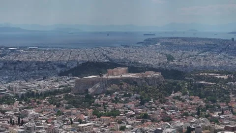 Acropolis of Athens and Parthenon overlooking sprawling city to Saronic Gulf Stock Footage 345372073