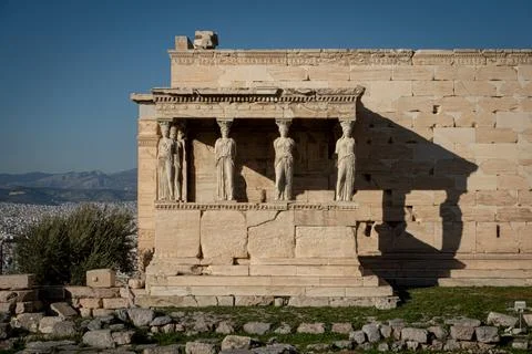 Acropolis complex statues in historical building with Athens in the back. G.. Stock Photos