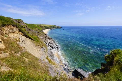 Across high eroding cliffs down to a secluded Porthbeor beach. Stock Photos