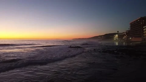Across Laguna Beach Waves at Sunset Stock Footage 154659898