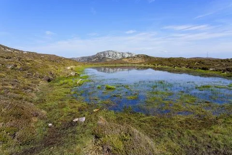 Across a shallow pool to a distant Holyhead mountain on Anglesey, Wales. Photos