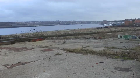 Across site of old ship yard looking to river Stock Footage 1090372