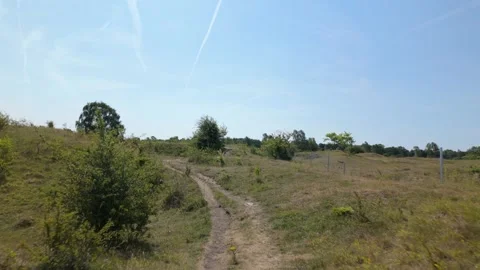 Across two small valleys and out the other side at Barnack Hills and Holes Stock Footage 340283473