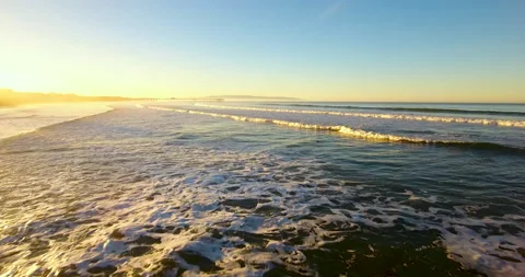 Across waves of Pacific Ocean. Low Flight. 4k Aerial Stock Footage 145164369