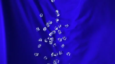 Acrylic cubes rolling down on blue fabric, Slow Motion Video stock 24817172
