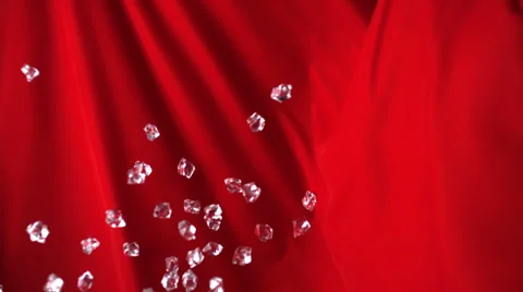 Acrylic cubes rolling down on red fabric, Slow Motion Stock Footage 24819333