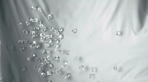 Acrylic cubes rolling down on white fabric, Slow Motion Stock Footage 24819220