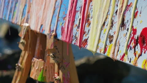Acrylic paint slowly flows down the canvas. Stock Footage 162784099
