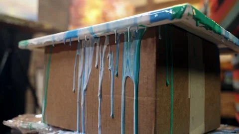 Acrylic paint is spreading over the canvas. Artistic collaboration in workshop. Stock Footage 156380468