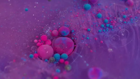 Acrylic particles mix floating ink oil drops flow Video stock 314875278