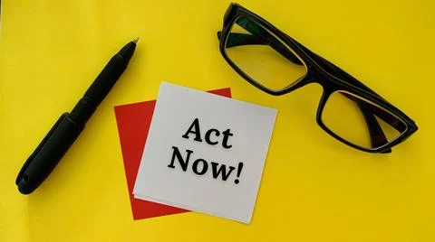 Act now - message on white notepad. With pen, glasses and yellow background Stock Photos
