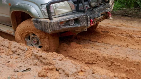 Action 4K slowmo of customized offroad tire spinning in heavy mud. Closeup .. Stock Footage 337805581