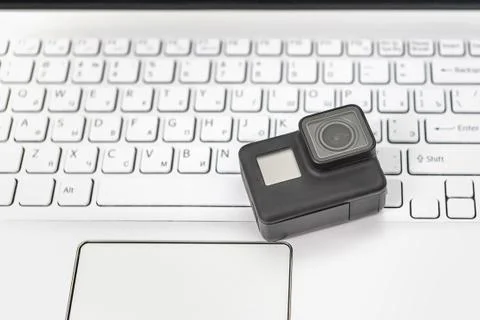 Action-camera on the background of a white laptop keyboard. 스톡 사진