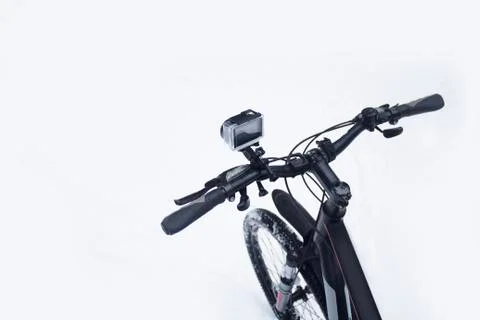 Action camera on a bicycle in a protective case in the winter on a snow. Stock Photos