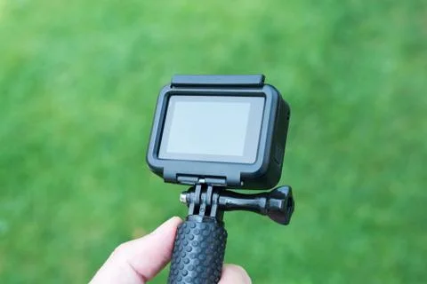 Action camera close-up on stick. Blank screen for mockup. Stock Photos