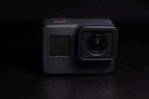 Action camera on a dark background. Isolated object. Front view. Stock Photos