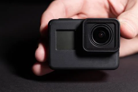 Action camera on a dark background. Isolated object. Front view. Stock Photos