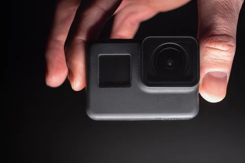 Action camera on a dark background. Isolated object. Front view. Stock Photos