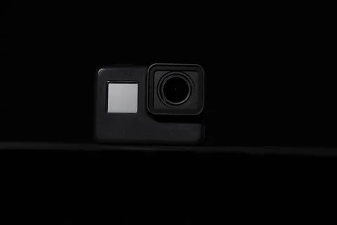 Action camera on a dark background. Isolated object. Front view. Stock Photos