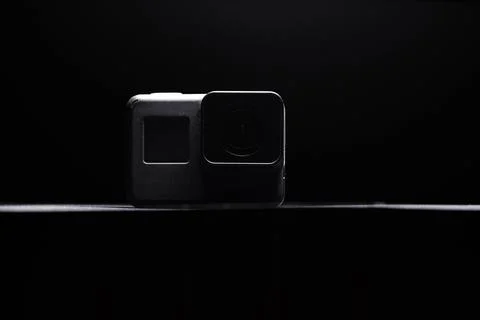 Action camera on a dark background. Isolated object. Front view. Stock Photos