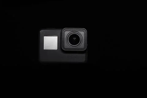 Action camera on a dark background. Isolated object. Front view. Stock Photos