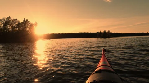 Action camera films kayaking in calm water. Silhouettes of small island Stock Footage 138535742