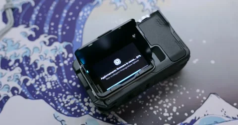 Action Camera Firmware Update In Progress On Screen Black Waterproof Housing Stock Footage 325277176