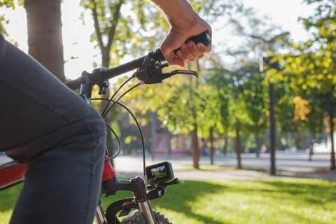 Action camera fixed next to the wheel of the bicycle on which the man rides Stock Photos