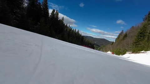 Action camera low angle view of skis of skier going downhill on alpine ski Stock Footage 241440676