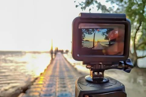 Action camera mounted on a tripod and make a time lapse of the pier and sunri Stock-Fotos