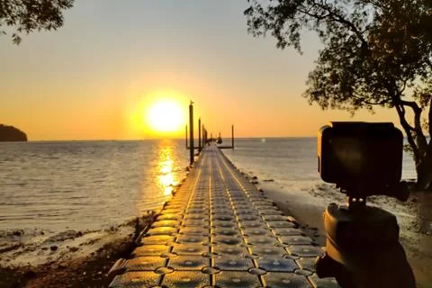 Action camera mounted on a tripod and make a timelapse of the pier and golden Stock Photos