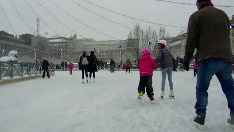 Action camera move smoothly in between crowd of people ice skating circular rink Stock Footage 70641232