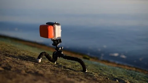 Action camera in plastic case on tripod near blue water Stock Footage 71063419