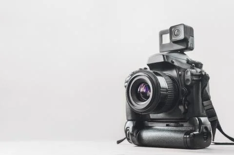 Action camera with a professional camera on a white background. Stock Photos
