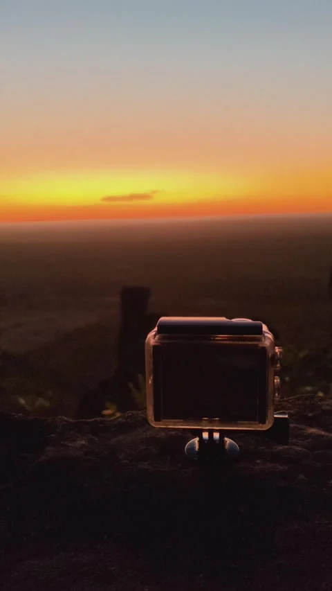 Action camera on a rock filming a scenic sunrise over a valley. Stock Footage 313240946