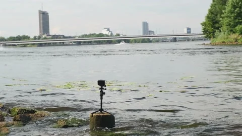 Action camera on small tripod fixed on stone on river bank Stock Footage 146325051