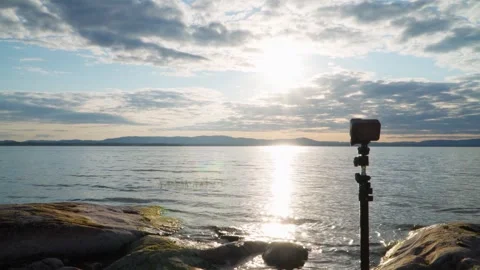 The action camera takes a time-lapse of the sky on the shore of the lake. Stock Footage 243701310