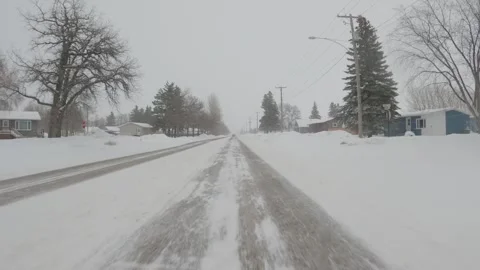 Action camera view while skiing along a groomed snowy ski trail through a forest Stock Footage 301107683