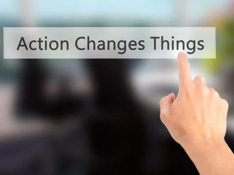 Action Changes Things - Hand pressing a button on blurred background concept  Stock Photos