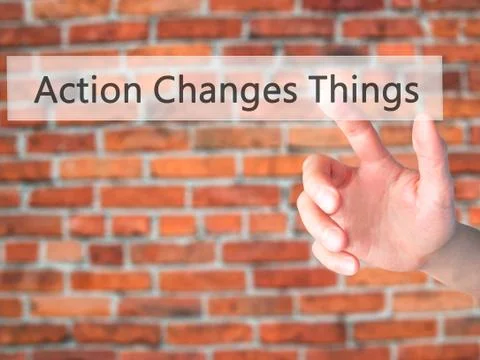 Action Changes Things - Hand pressing a button on blurred background concept  Stock Photos