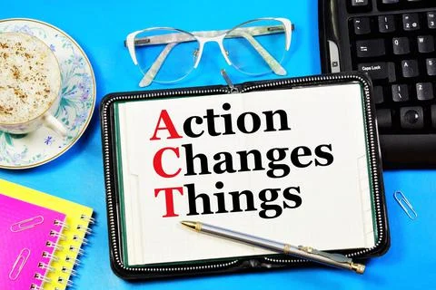 Action changes things. A text label in a working notebook. Stock Photos