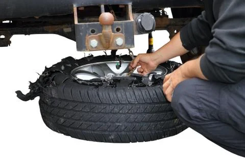 Action of changing an exploded truck wheel, isolation over white background Stock Photos