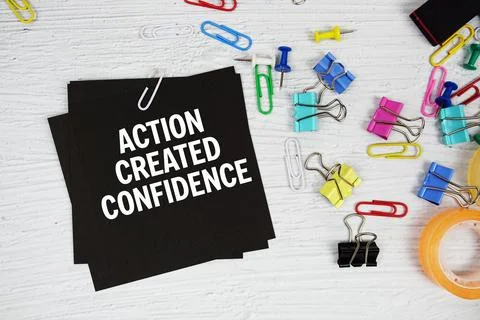 Action Created Confidence text on stick note with stationery on concrete ba.. Stock Photos