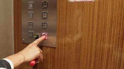 Action of a hand pressing the button for the first floor inside an old elevator Stock Footage 301526503
